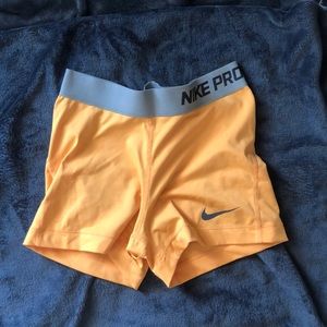 Orange Nike Pro Spandex shorts
